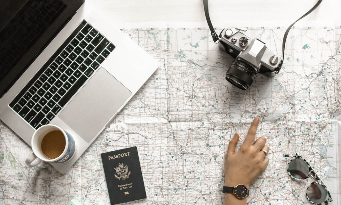 A traveler reviewing a US passport and map at a desk